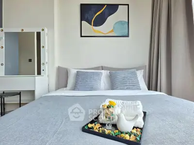 Modern bedroom with stylish decor and cozy bedding in a contemporary apartment.