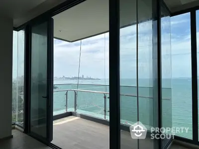 Stunning ocean view from modern glass balcony in high-rise apartment