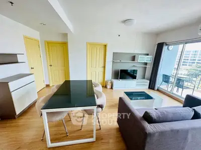 Modern living room with sleek furniture and large windows offering a bright and airy atmosphere.