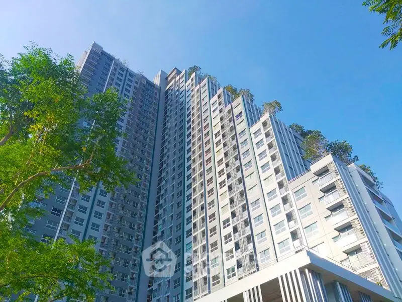 Stunning high-rise building with lush rooftop greenery and modern design.
