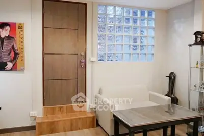 Cozy living room with modern decor and unique glass block window