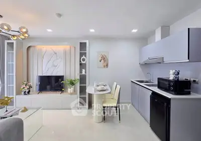 Modern open-plan living room and kitchen with sleek design and elegant decor.