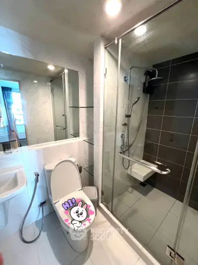 Modern bathroom with glass shower and stylish fixtures in a contemporary apartment.