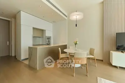 Modern open-plan kitchen and dining area with sleek design and natural lighting.