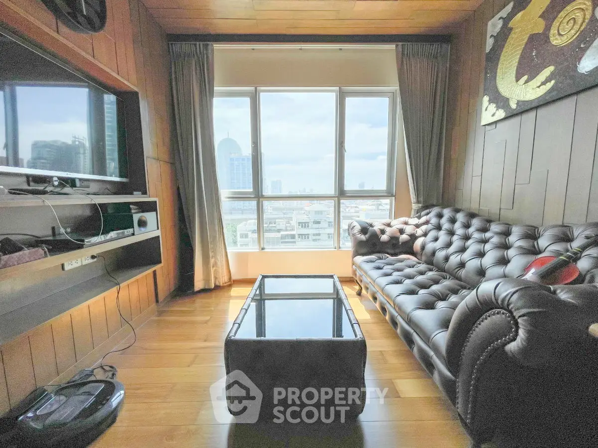 Chic living room with leather sofa and city view, perfect for urban living.