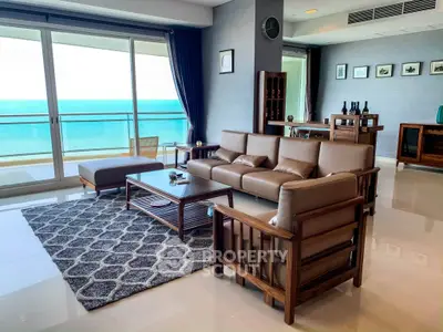 Luxurious living room with ocean view, elegant furniture, and large windows in a modern apartment.