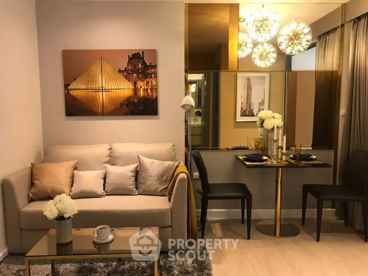 Elegant living room with modern decor and cozy dining area, featuring stylish lighting and artwork.