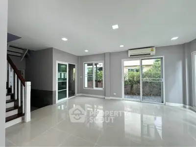 Spacious modern living room with large windows and garden view