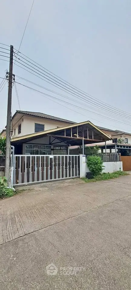 Charming suburban house with gated entrance and spacious driveway, perfect for family living.