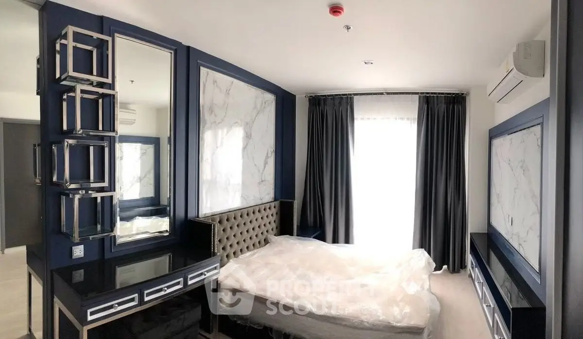 Luxurious bedroom with modern decor and large window for natural light