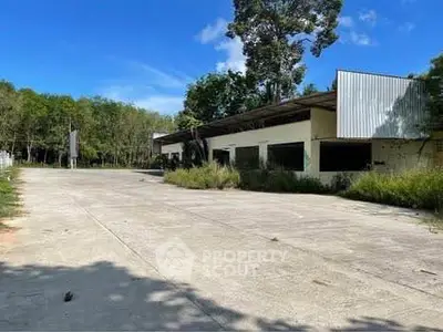 Spacious commercial property with ample parking and lush greenery, ideal for business opportunities.