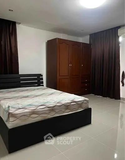 Spacious bedroom with modern furniture and ample natural light