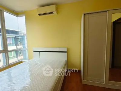 Bright bedroom with large windows and modern furniture in a stylish apartment.
