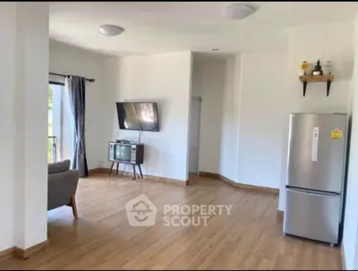 Spacious living room with modern decor and sleek appliances, perfect for contemporary living.