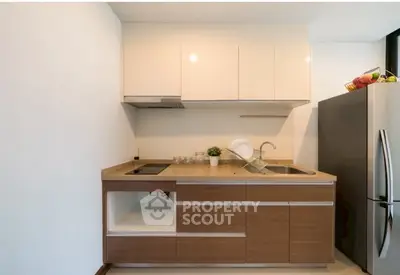 Modern kitchen with sleek cabinets and stainless steel fridge