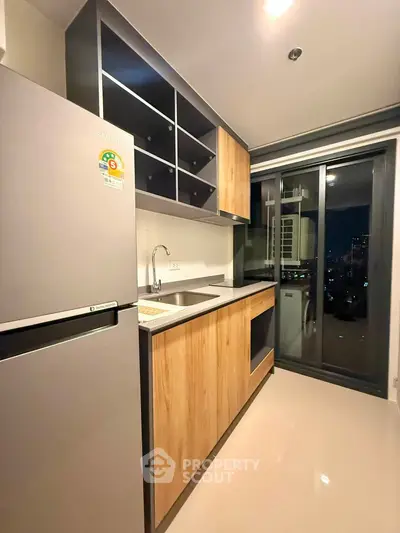 Modern kitchen with sleek cabinets and city view from window
