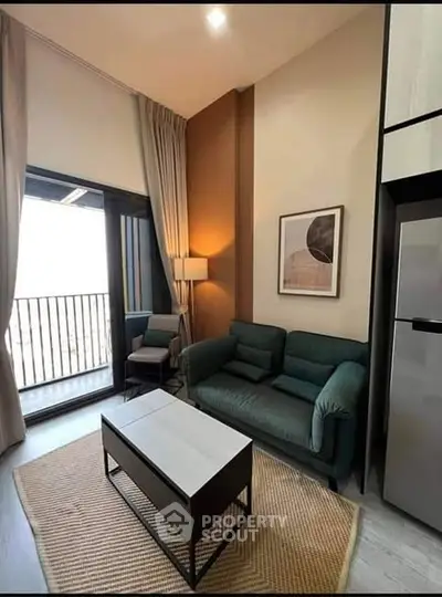 Modern living room with balcony view, stylish furniture, and natural light.