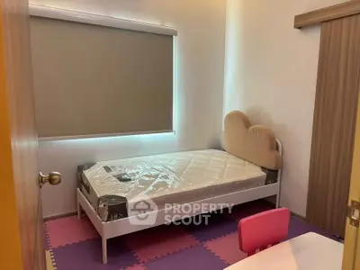 Cozy small bedroom with single bed and playful decor