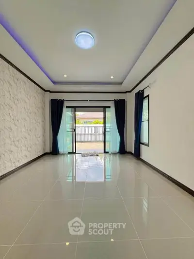 Spacious living room with modern design and large windows for natural light.