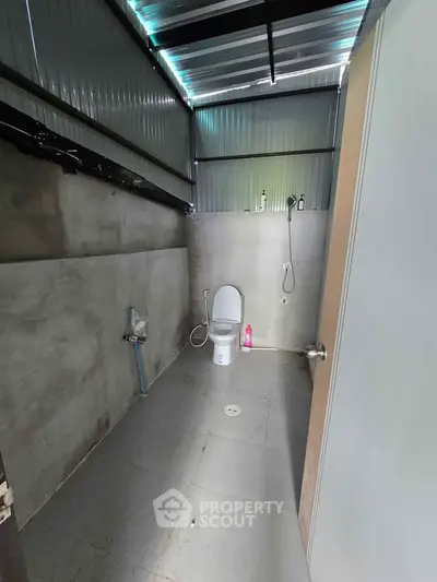 Minimalist bathroom with concrete walls and modern fixtures