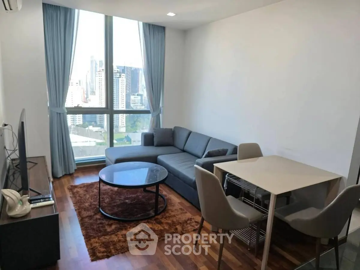 Modern living room with city view, stylish furniture, and wooden flooring