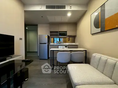 Modern living room with sleek kitchen and stylish decor