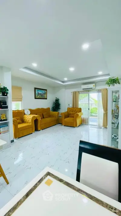 Spacious living room with elegant yellow sofas and modern decor