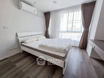 Modern bedroom with large window and stylish decor in a bright apartment