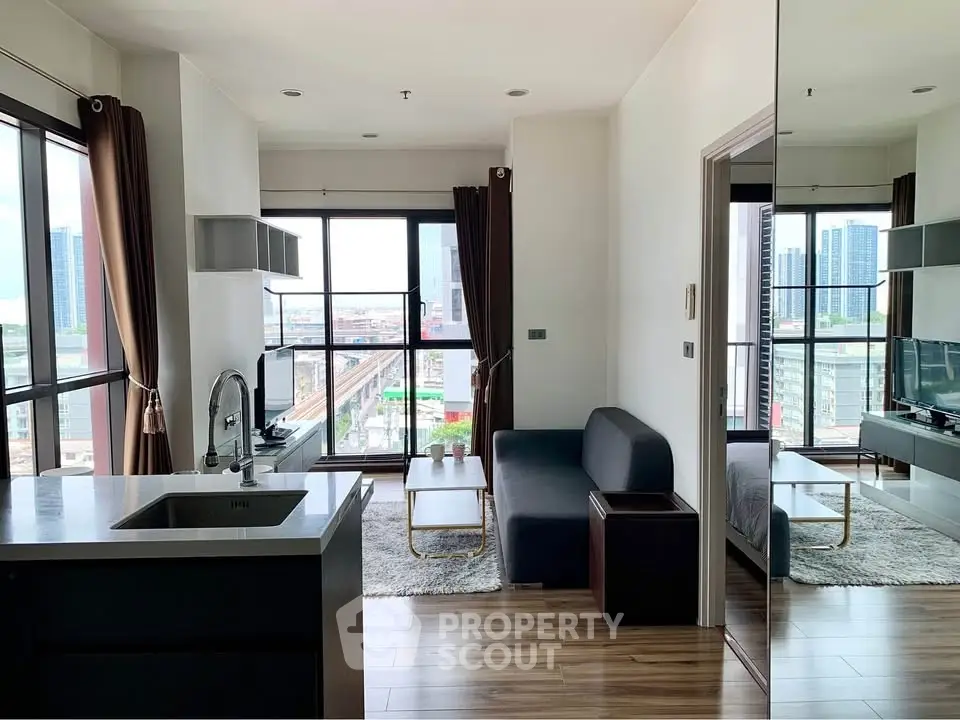 Modern apartment with open layout, featuring a cozy living area and city view.