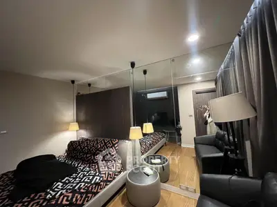 Modern bedroom with mirrored wall and stylish decor