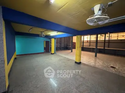 Spacious commercial space with vibrant colors and ample lighting, ideal for retail or office setup.