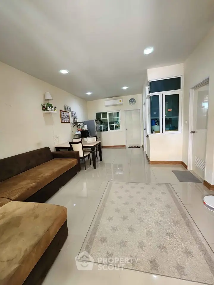Spacious living room with modern decor and ample natural light
