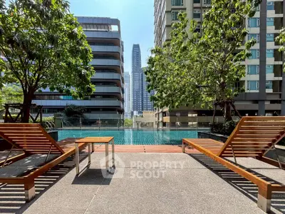 Luxurious urban poolside with modern high-rise view and lush greenery
