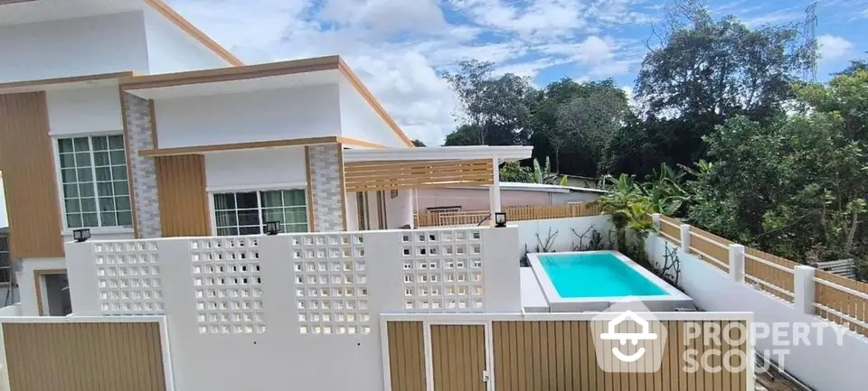 Modern house exterior with private pool and lush greenery