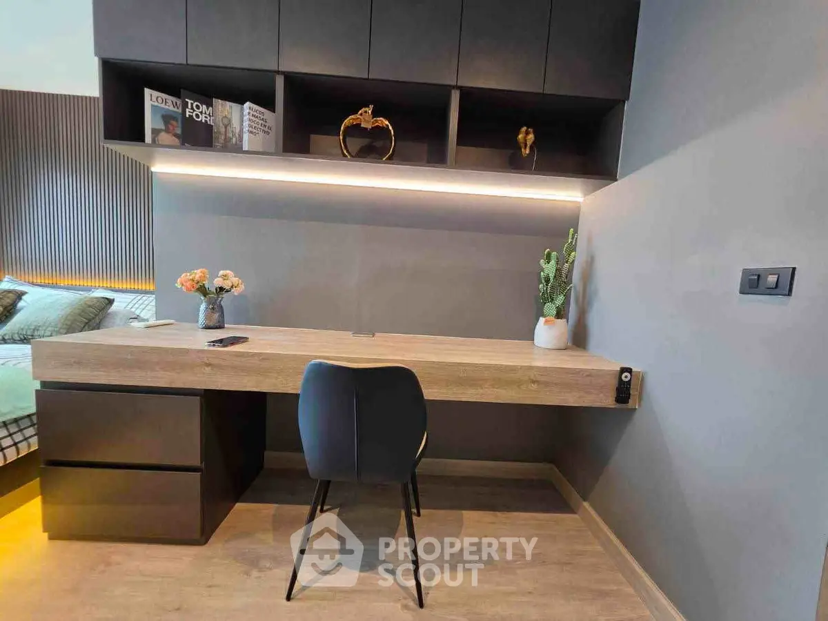 Modern study room with sleek desk, chair, and stylish shelving in a contemporary apartment.