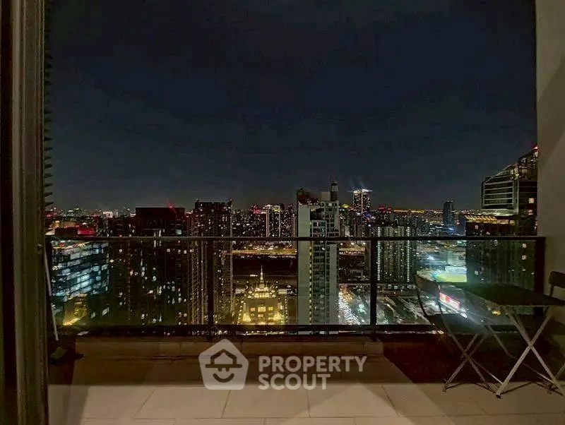 Stunning city skyline view from a modern balcony at night.