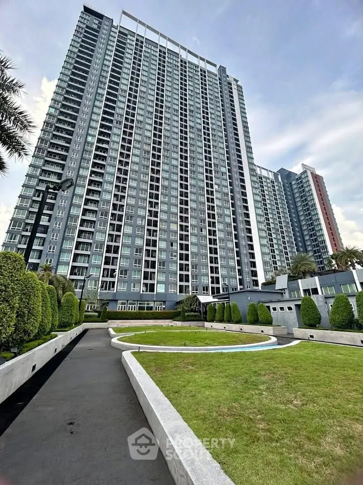 Stunning high-rise building with modern architecture and lush green landscaping.