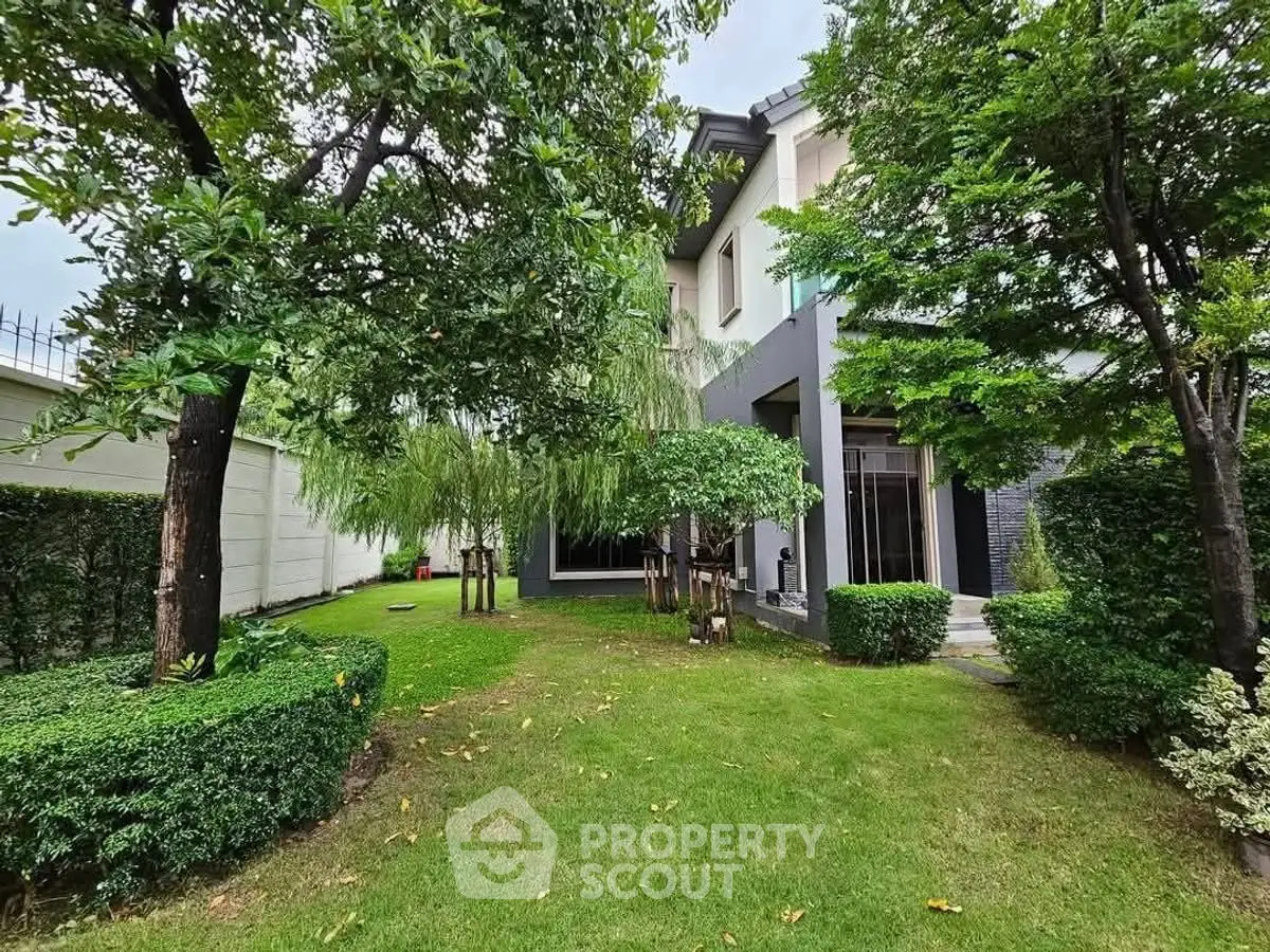 Beautiful garden view of modern home with lush greenery and manicured lawn