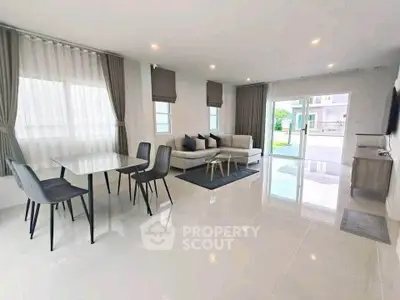 Spacious modern living room with elegant dining area and large windows