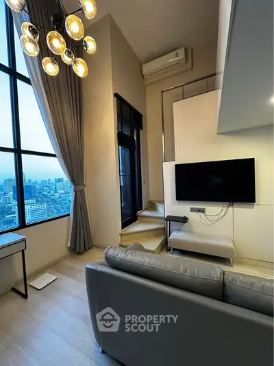 Modern living room with city view, stylish lighting, and sleek furniture in a high-rise apartment.