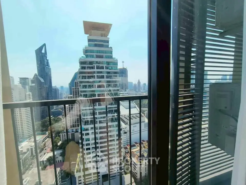 Stunning cityscape view from a modern balcony in a high-rise building.
