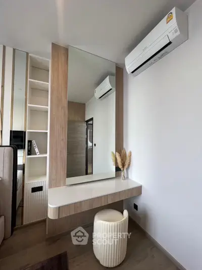 Modern bedroom with stylish vanity and air conditioning unit