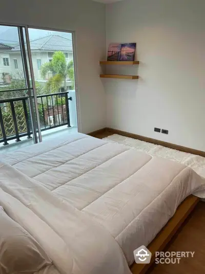 Cozy bedroom with balcony view in modern apartment