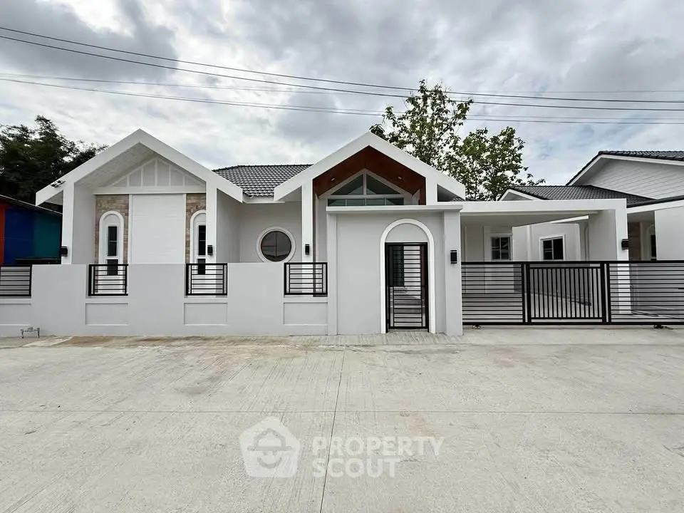 Modern white house exterior with stylish design and gated entrance