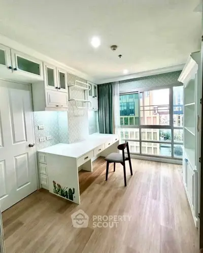Bright study room with large window and modern desk in stylish apartment