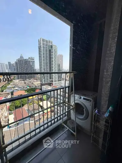High-rise balcony with city view and washing machine, perfect for urban living.