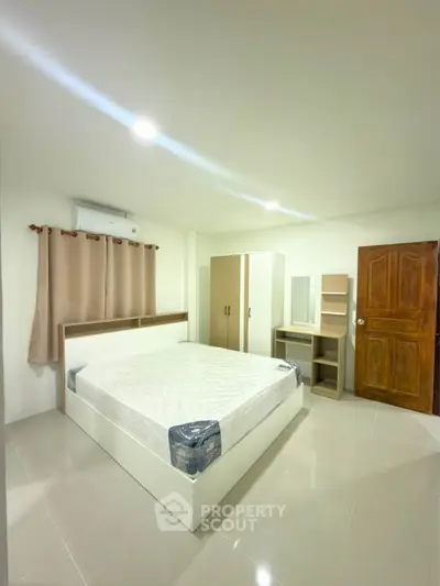 Spacious bedroom with modern furnishings and ample natural light