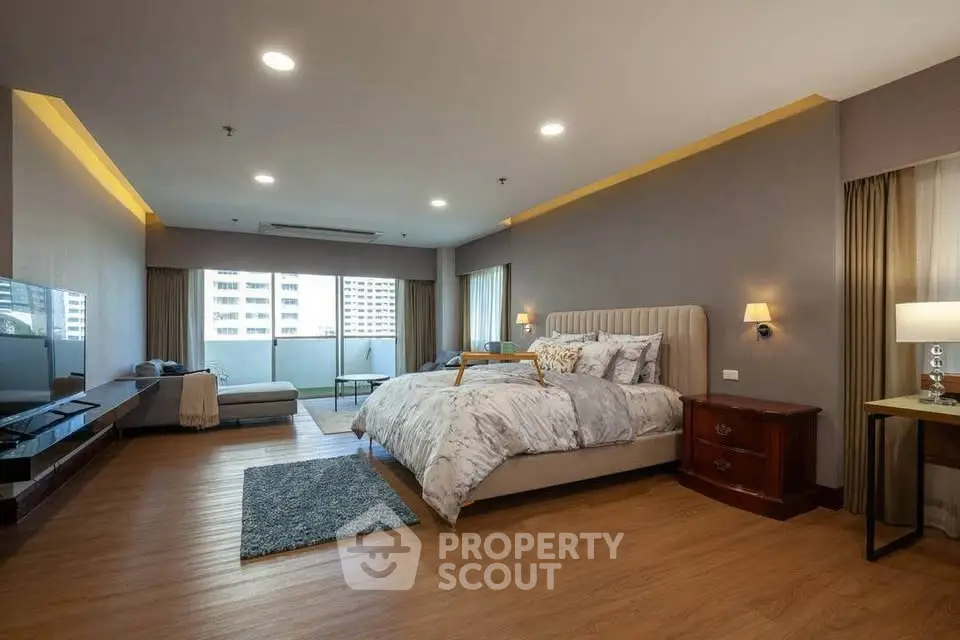 Spacious modern bedroom with balcony and elegant decor