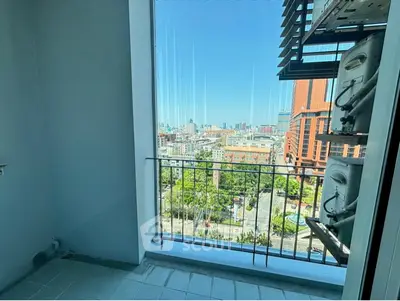 Stunning city view from a modern apartment balcony with ample natural light.