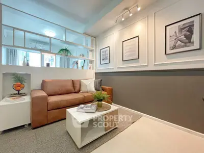 Stylish living room with modern decor and cozy seating in a contemporary apartment.